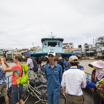 Mekong ferry boarded with both locals and tourists departing mekong city