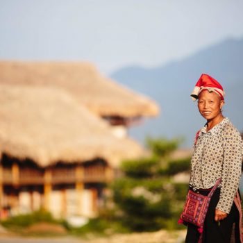 Local Red Dao minority woman welcoming guests at Topas Ecolodge entrance