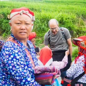 Tourist buying local handcraft from Red Zao minority women