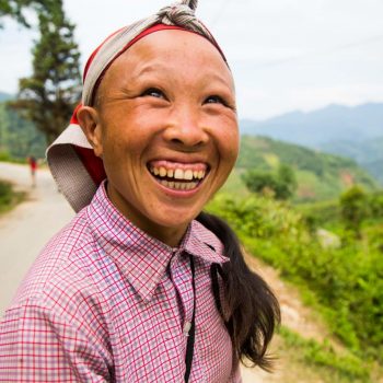 Red Dao villager smiling towards camera in Sapa