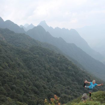 VMM runner posing in front of cloudy Sapa mountains